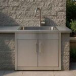 A weatherproof stainless steel outdoor kitchen sink cabinet with a sink, and faucet.